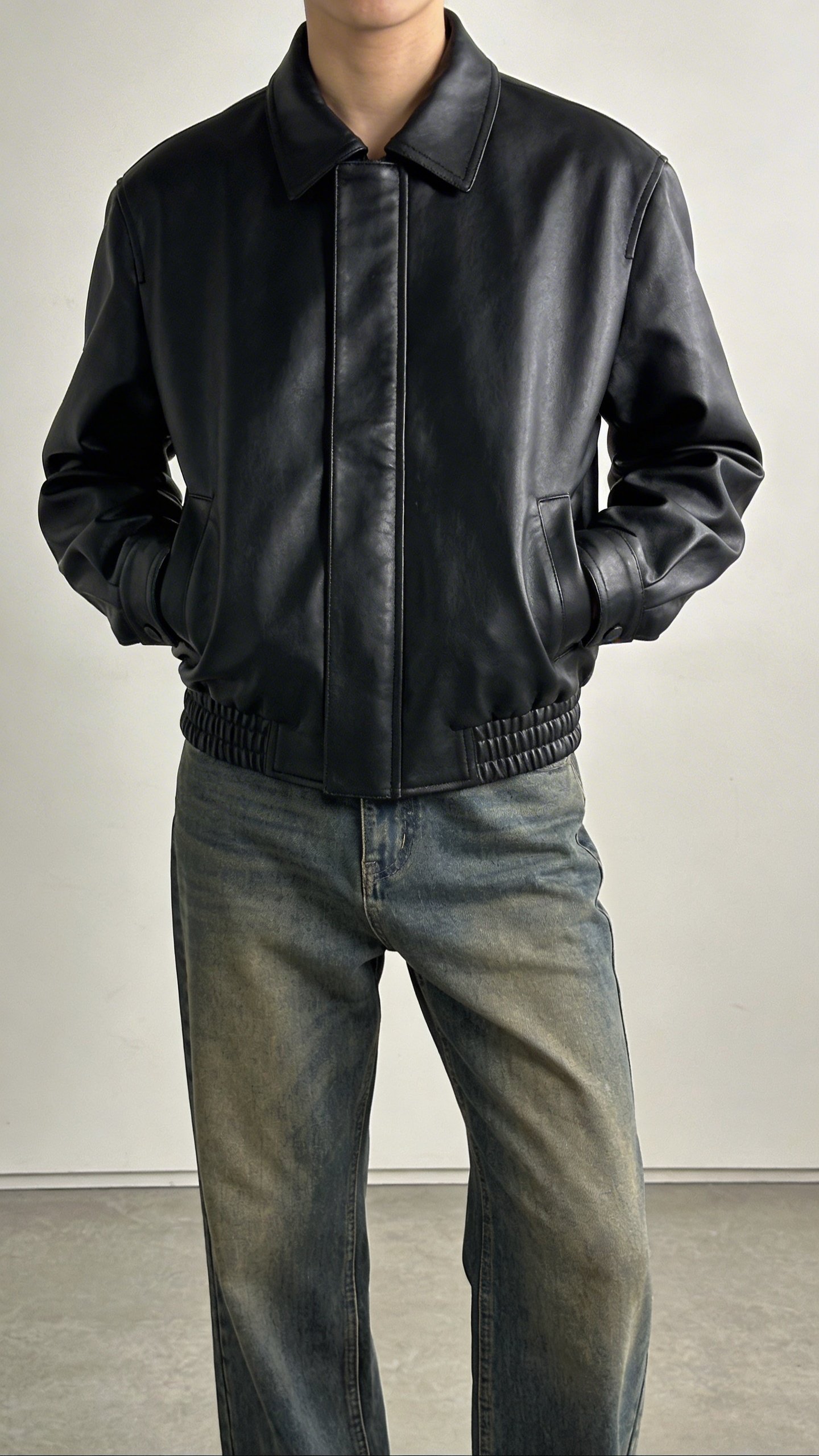 Black leather jacket styled with medium wash jeans