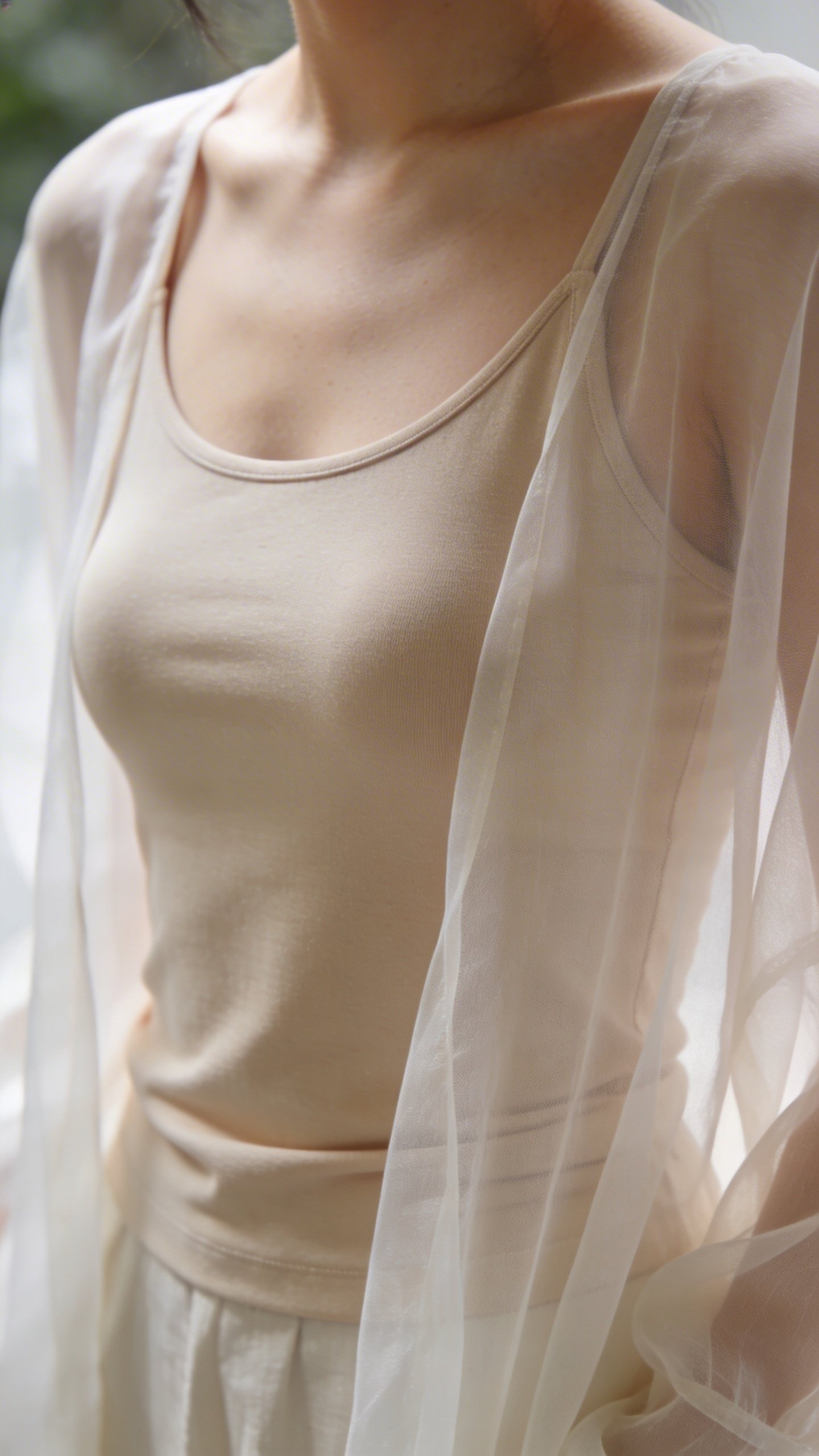 Beige seamless cami layered beneath sheer chiffon top