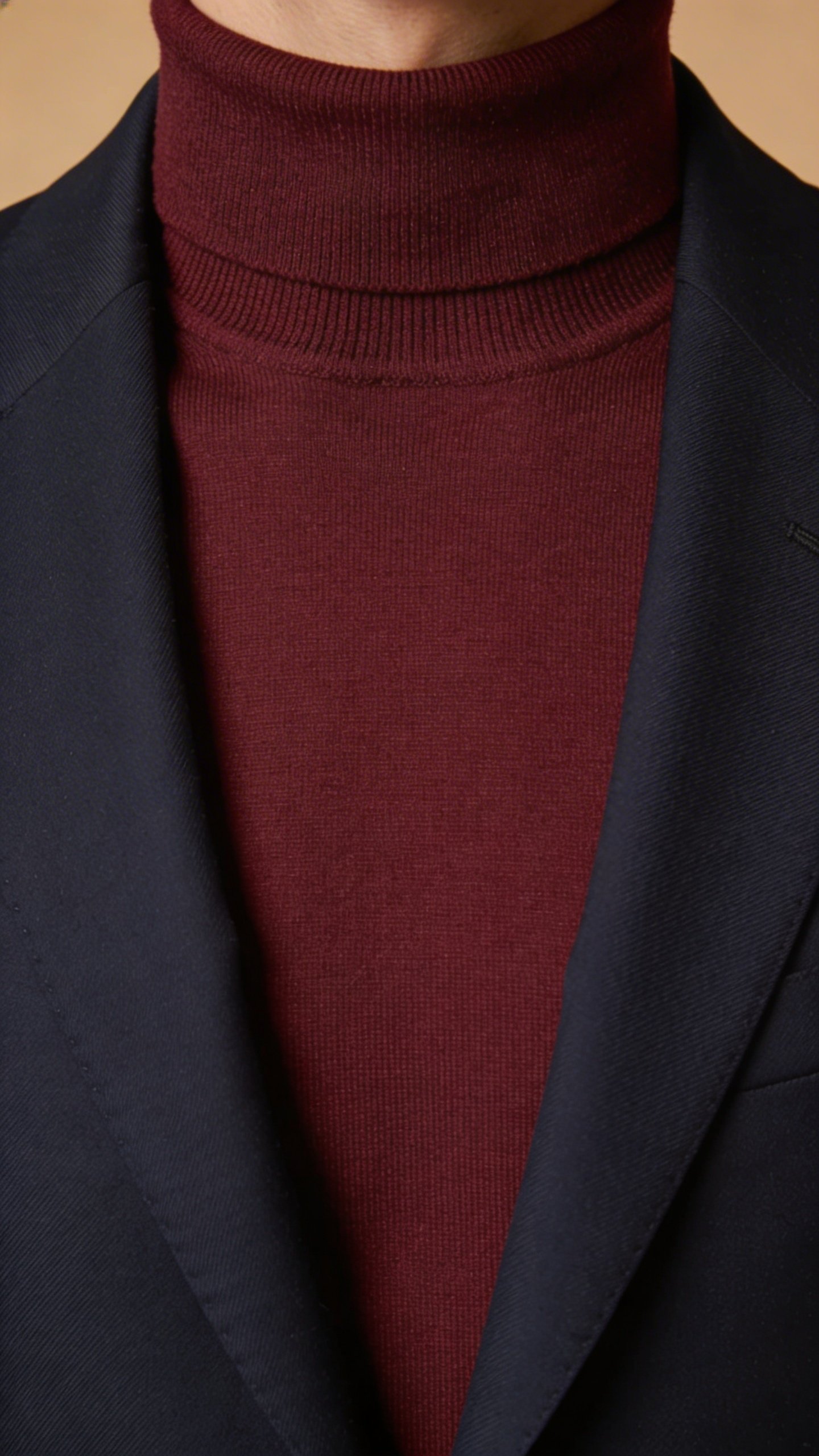 Burgundy turtleneck layered with navy blazer torso view