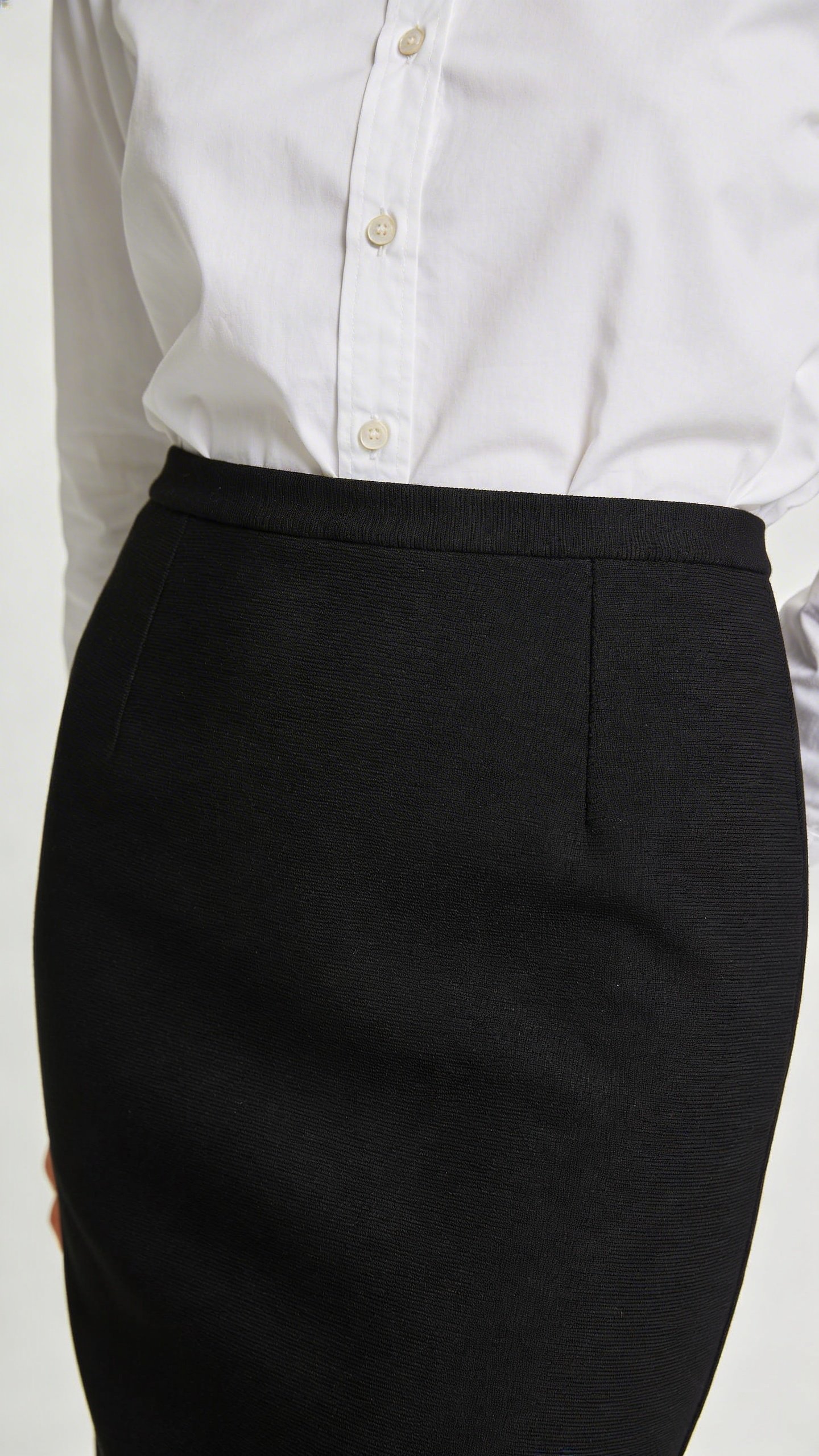 Black pencil skirt with white button-down closeup