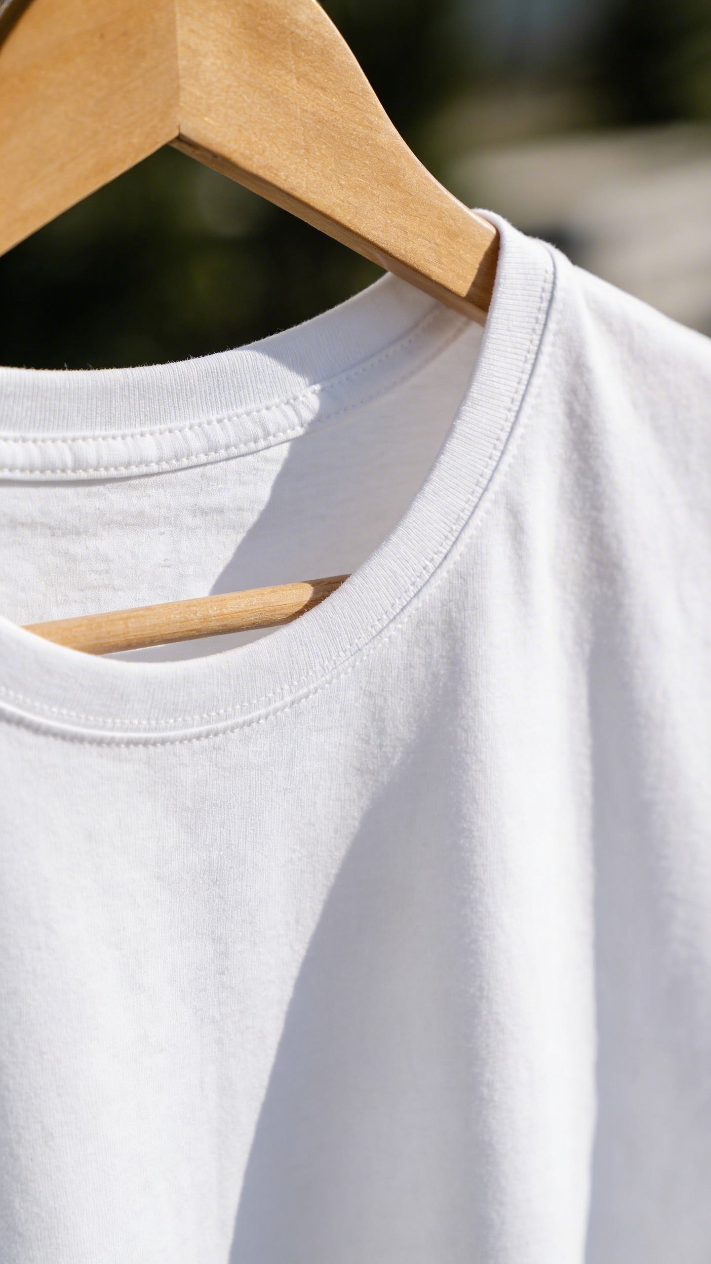 Closeup of crisp white cotton t-shirt on hanger