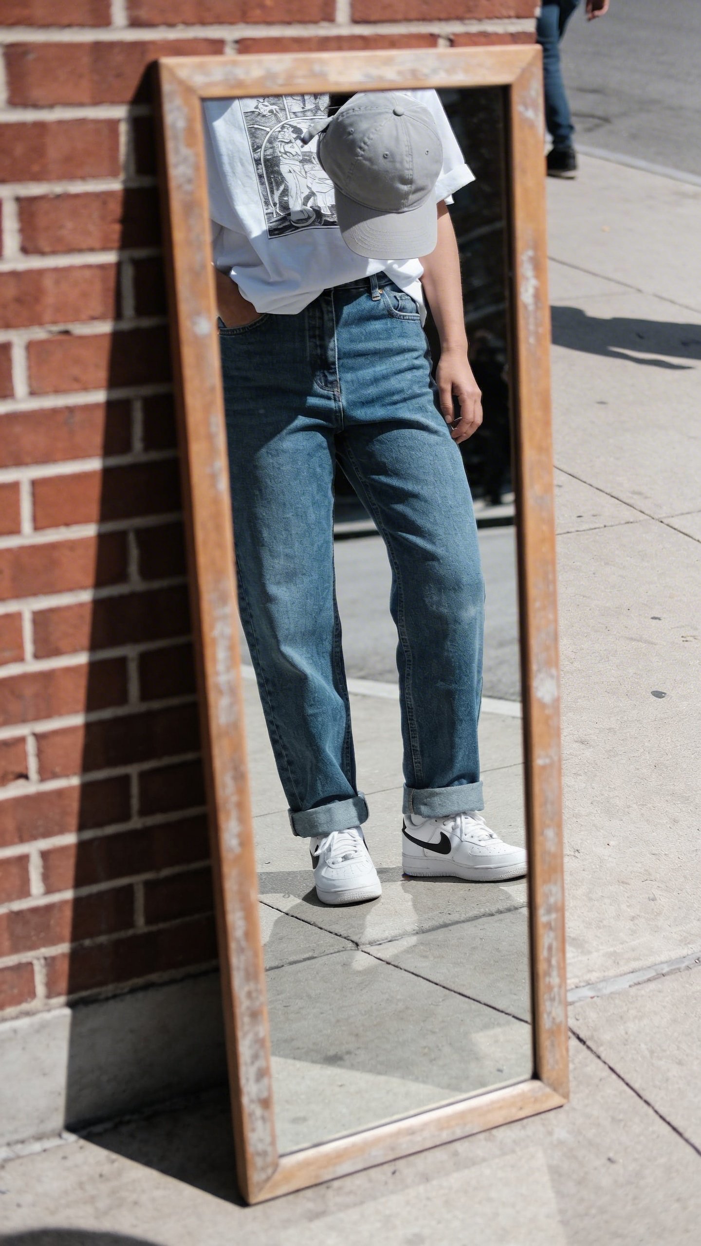 Full length mirror reflecting casual street style outfit