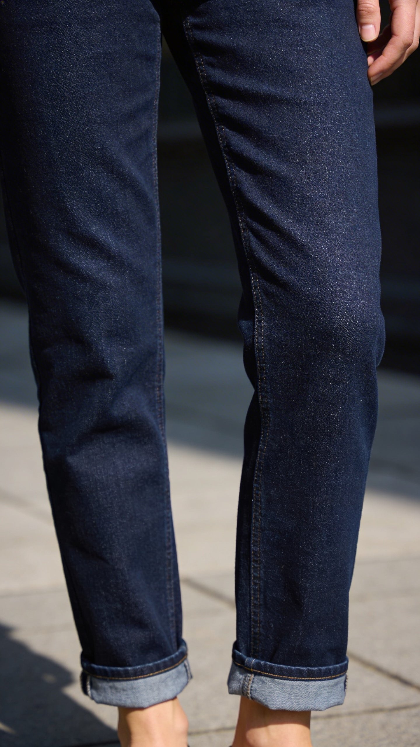 Well-fitted dark wash denim jeans at ankle
