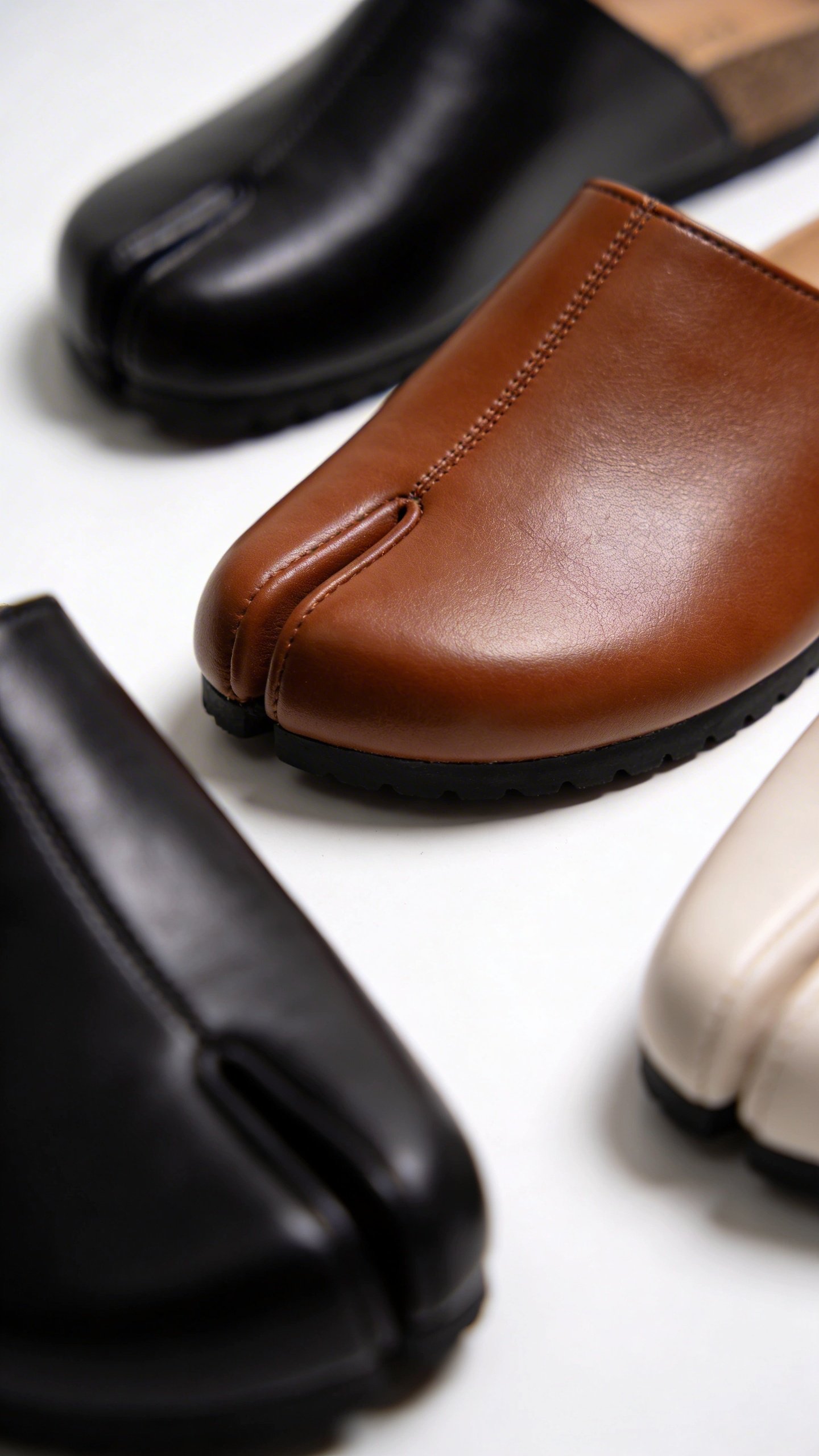 Closeup of modern leather clogs on white background