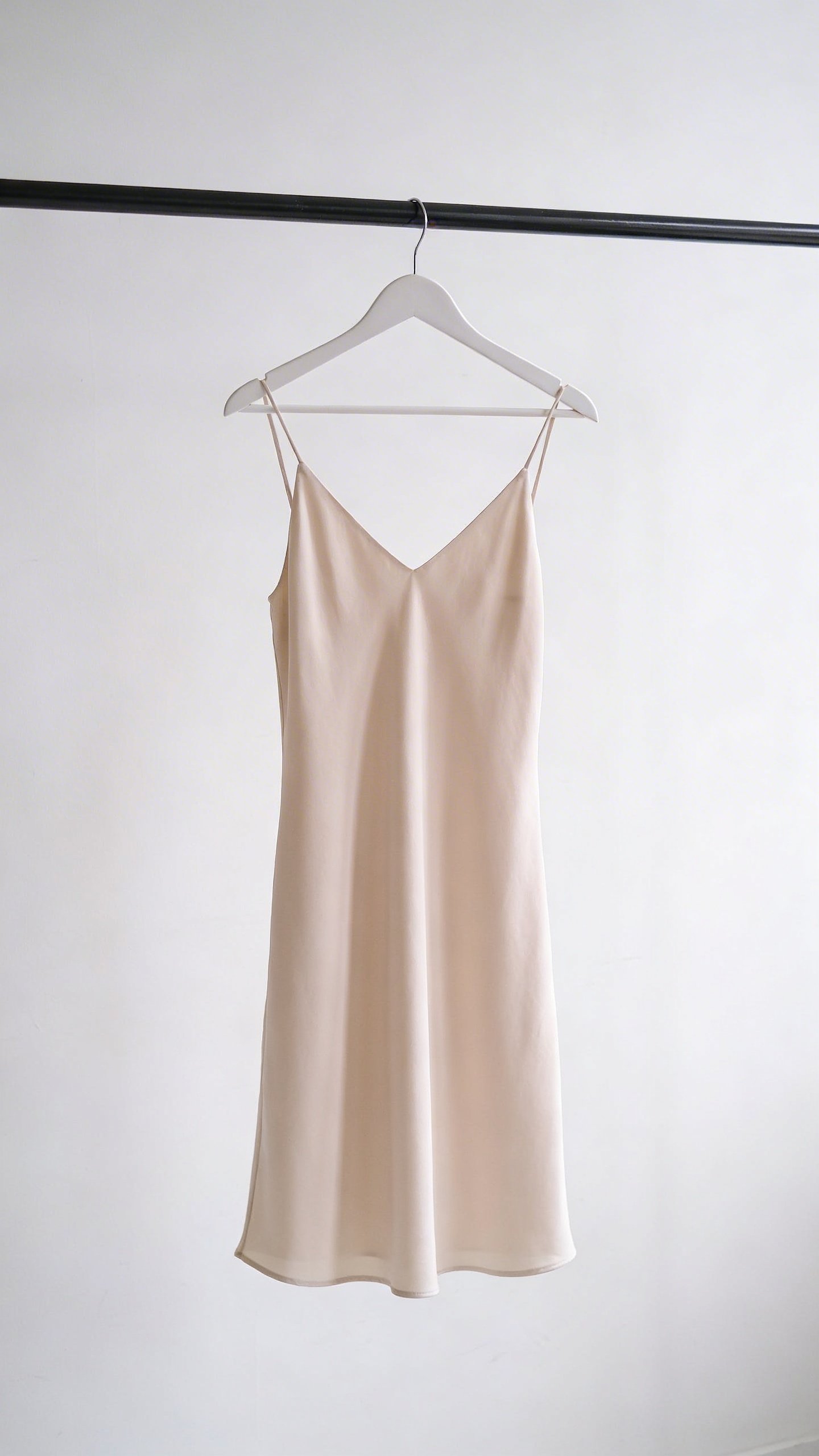 Single minimalist slip dress on white hanger