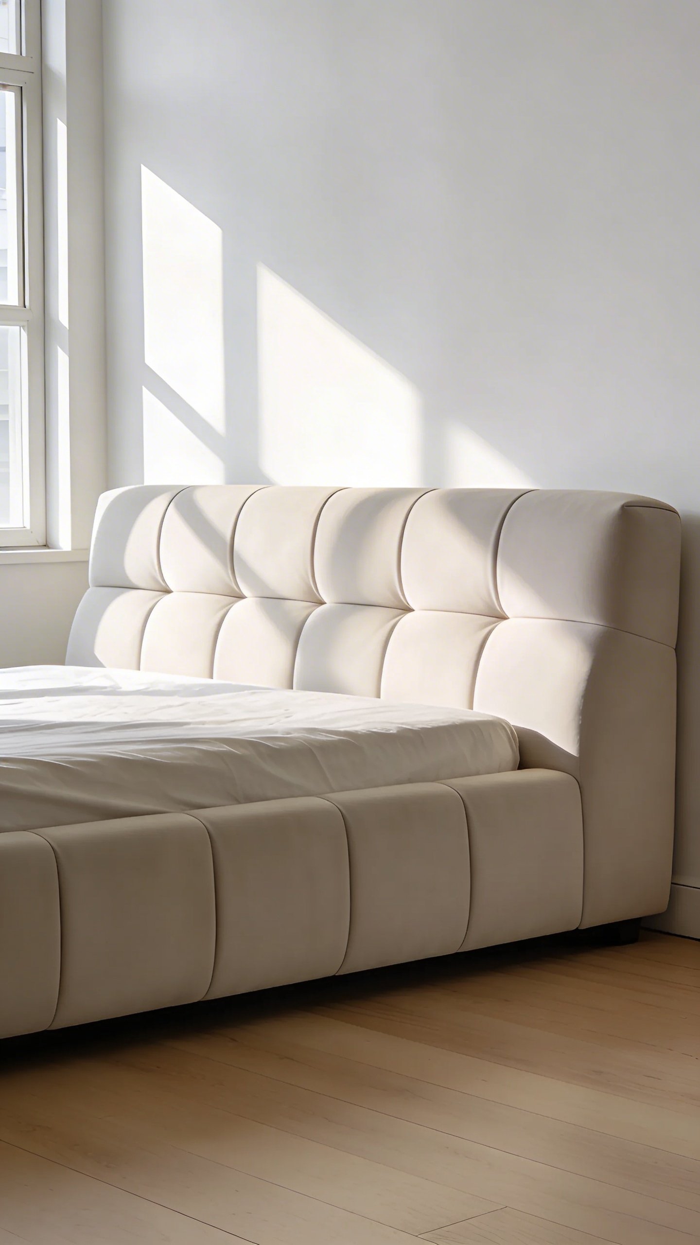 Modern upholstered bed centered against white wall