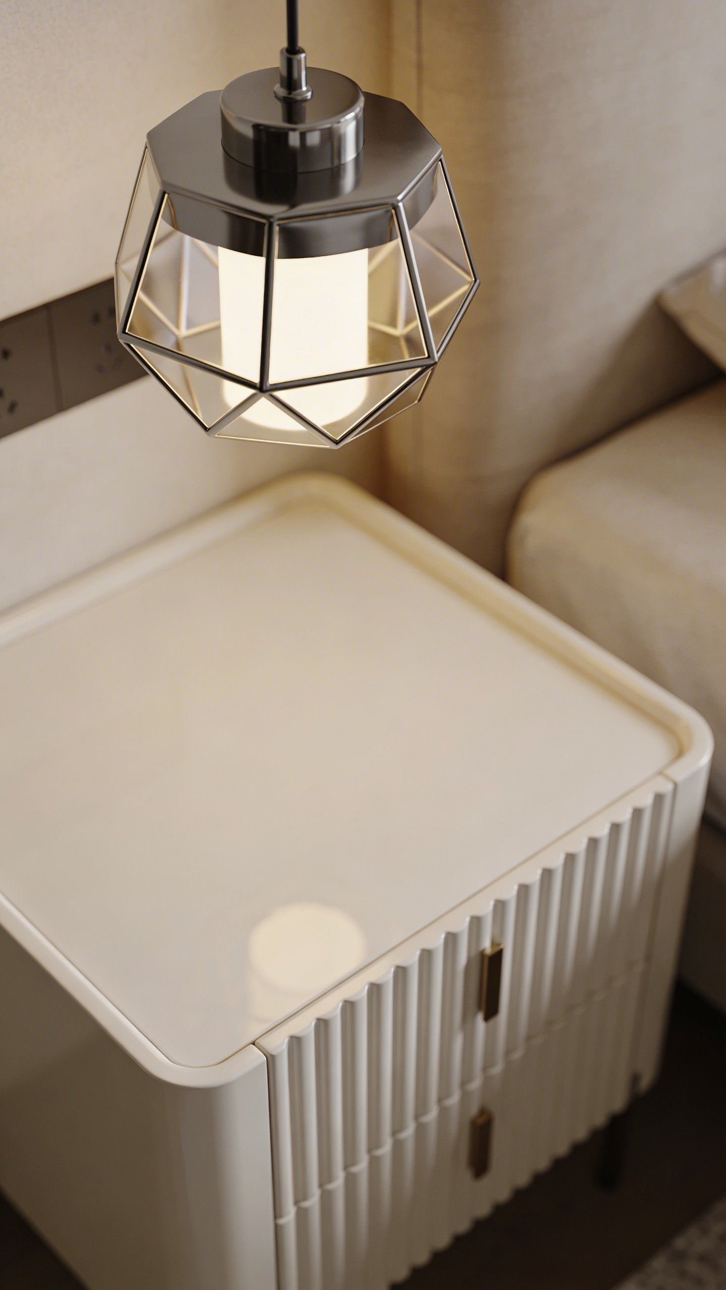 Modern pendant light hanging above white nightstand closeup