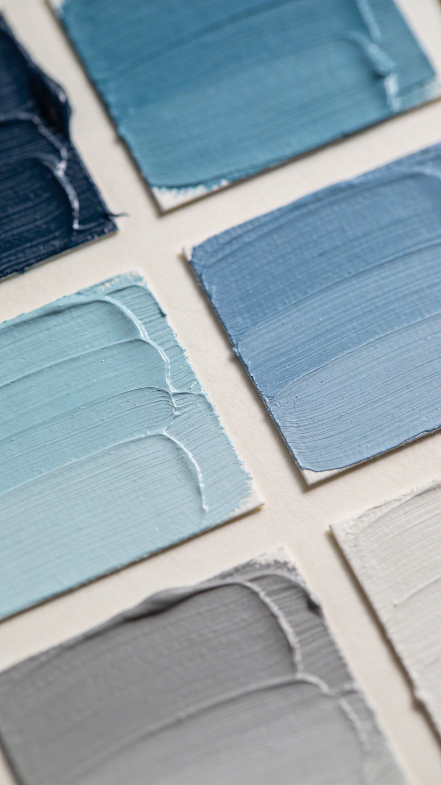 Closeup of paint color swatches in soft blues and grays