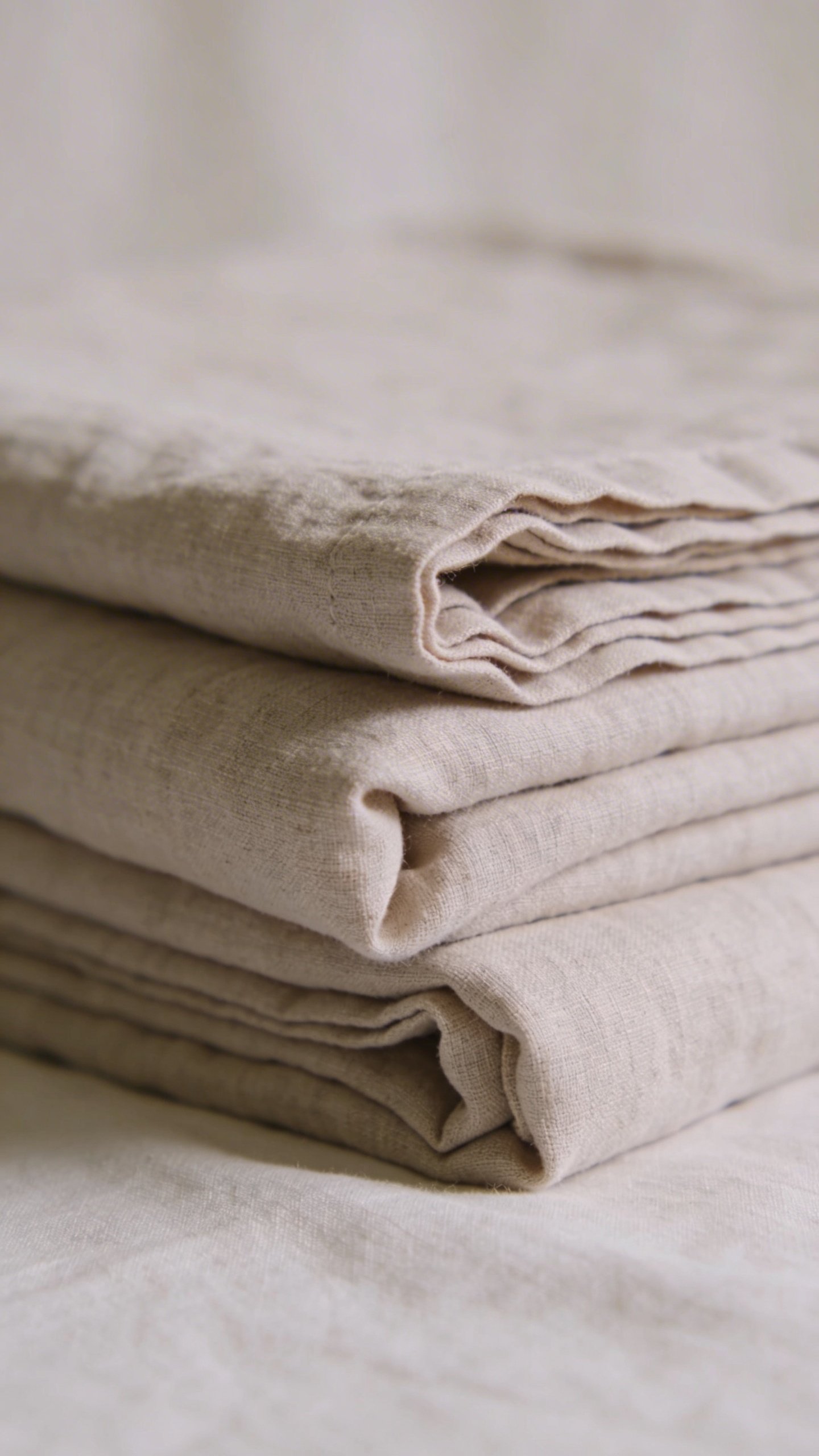 Closeup of folded neutral linen bedding stack