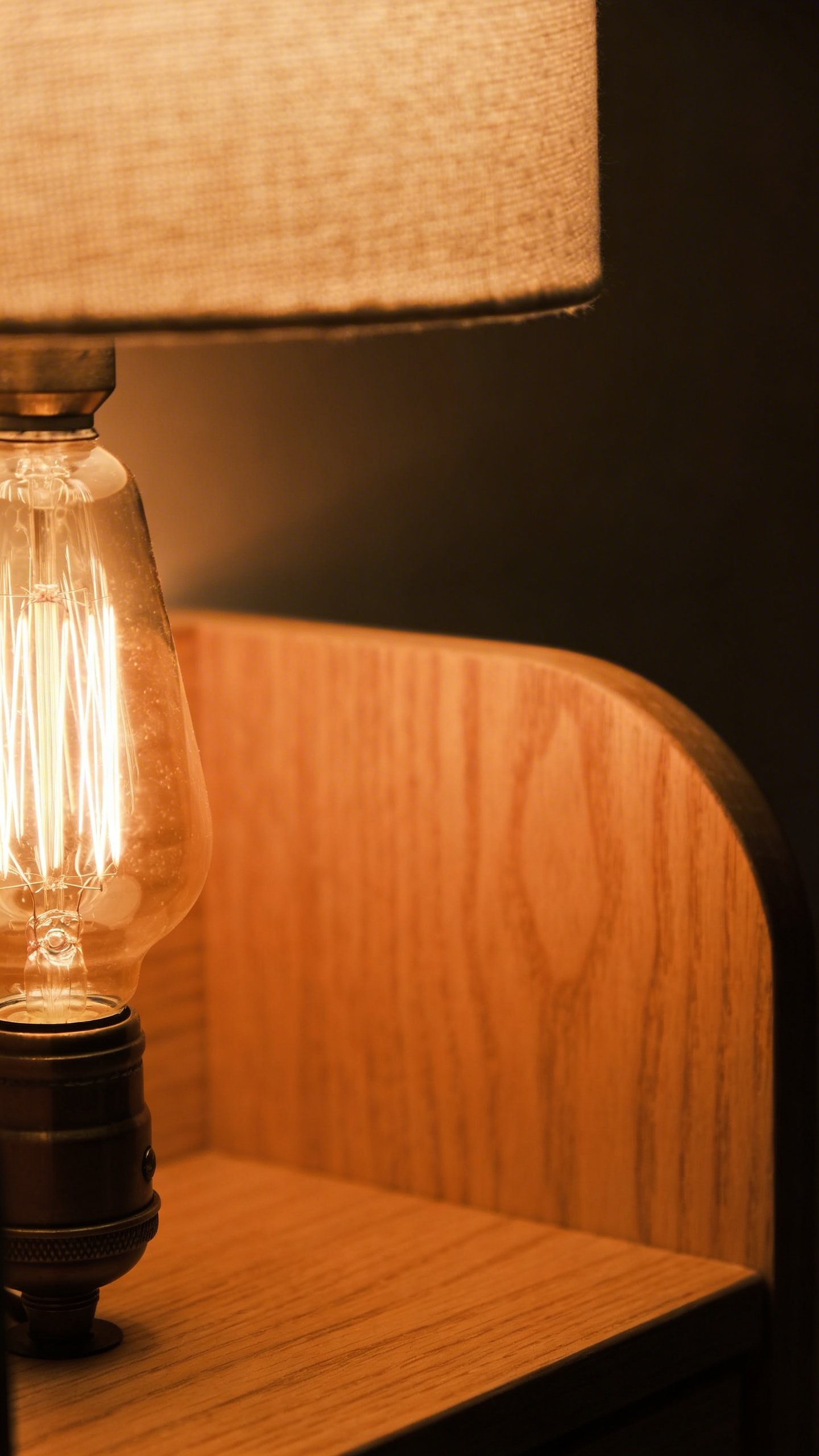 Warm Edison bulb table lamp on wooden nightstand