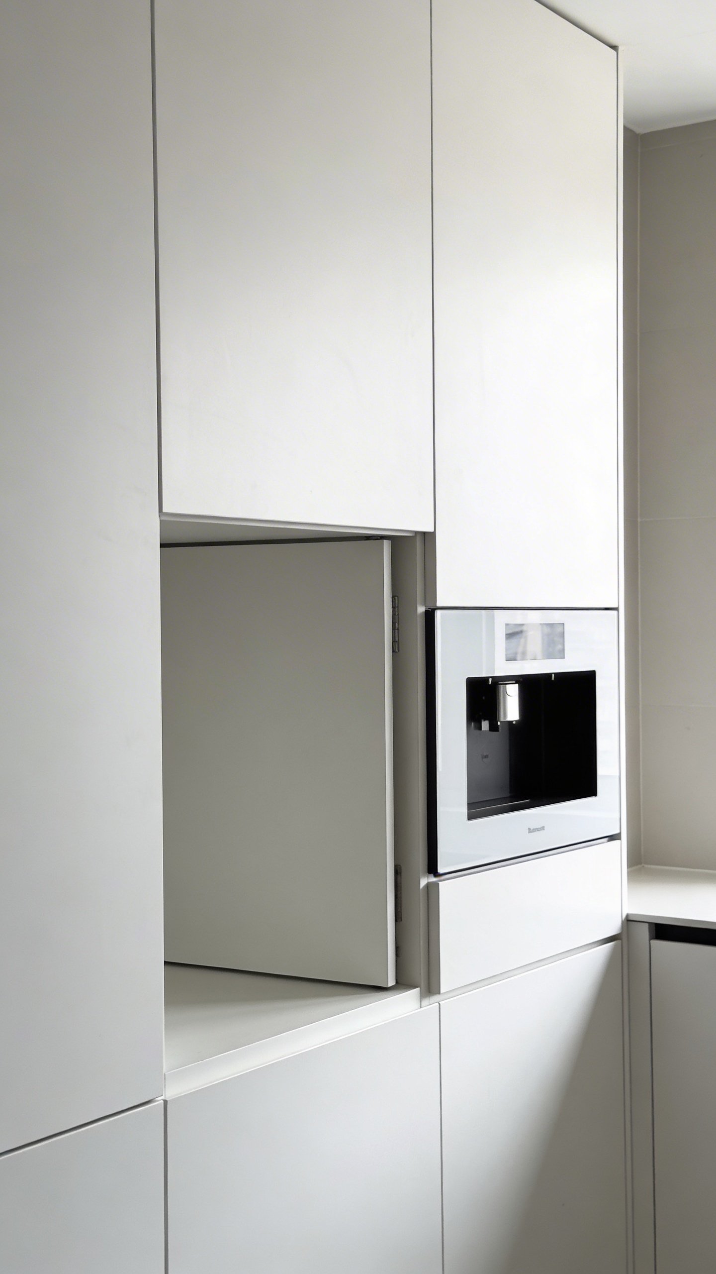 Modern white kitchen cabinet with hidden microwave compartment