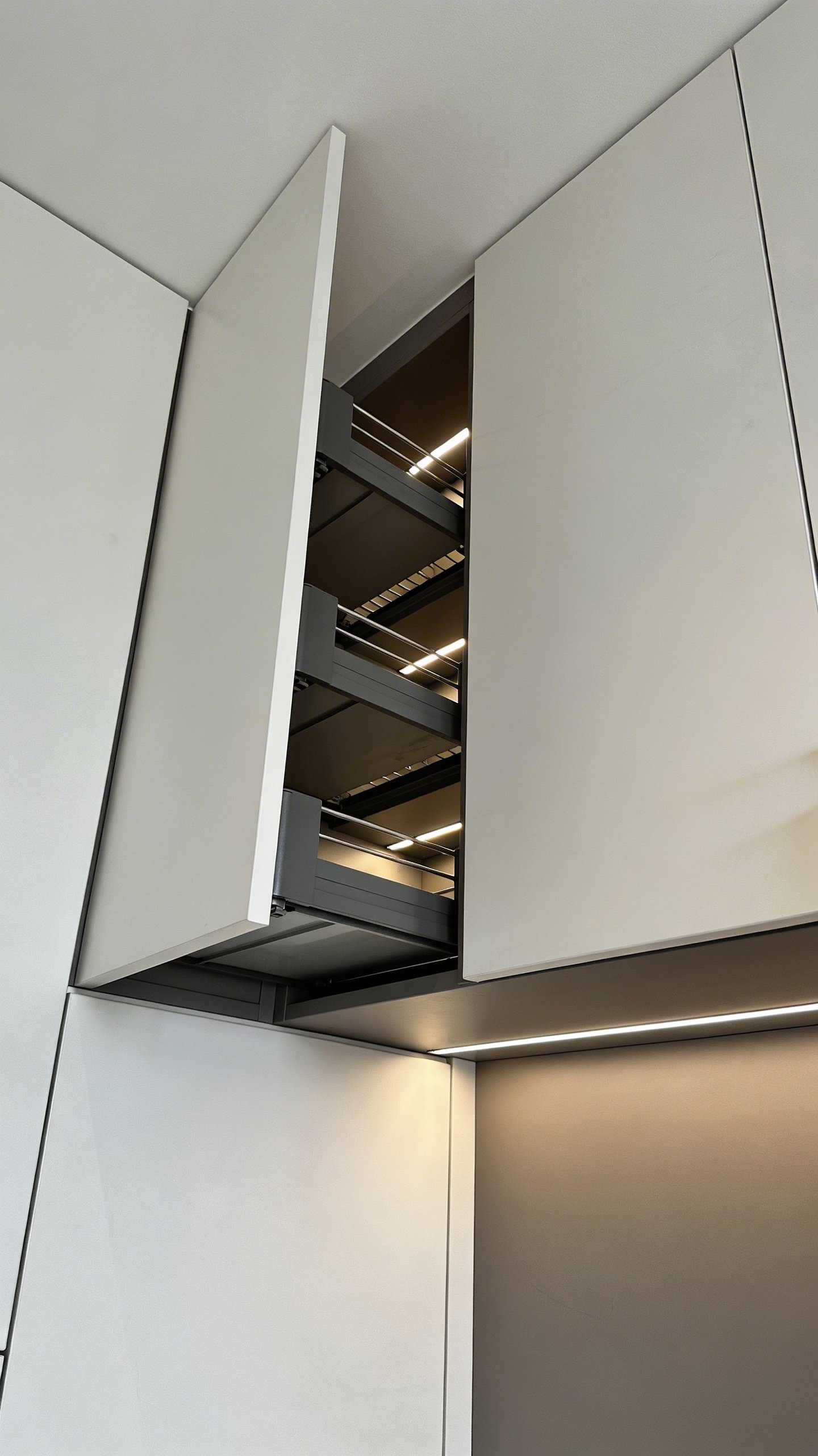 Modern corner kitchen cabinet with open door showing depth