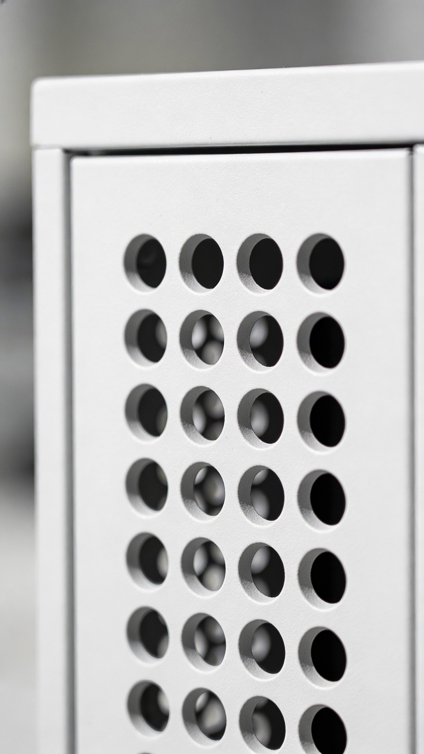 Closeup of ventilated cabinet door with airflow holes