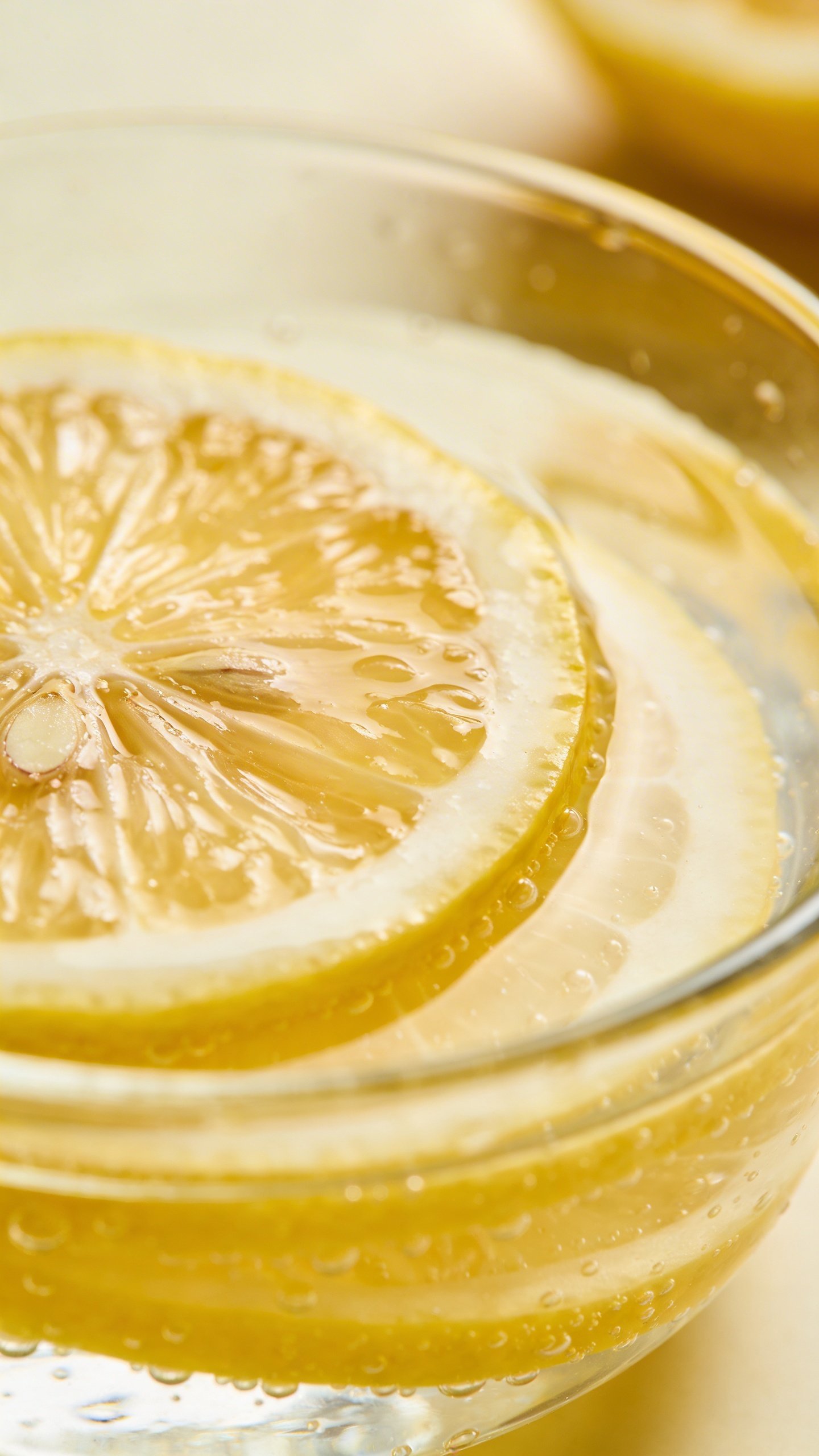Closeup of fresh lemon slices in clear glass bowl