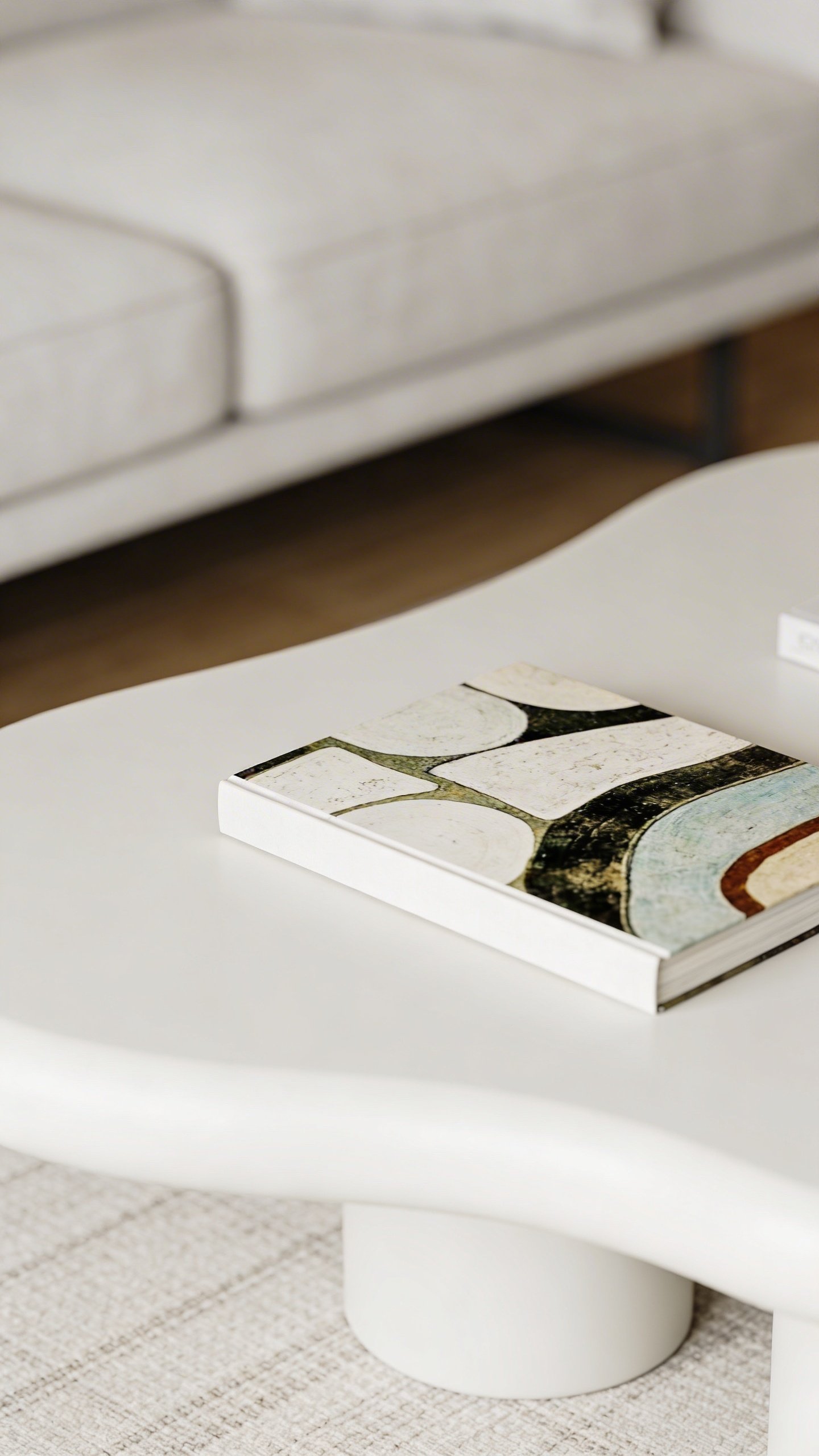 Uncluttered white coffee table with one art book