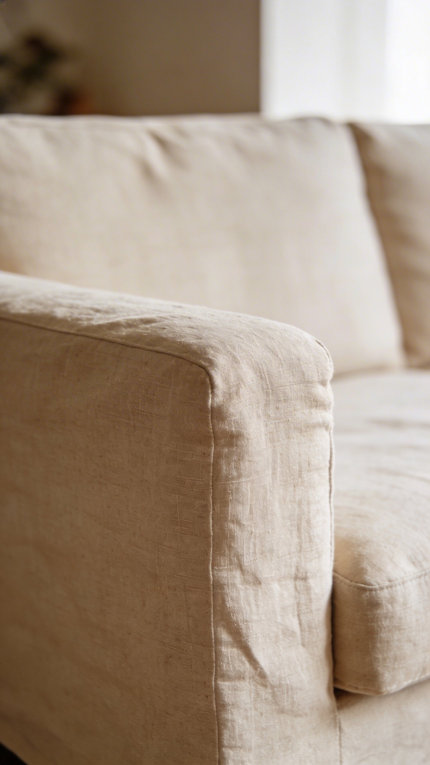 Closeup of beige linen sofa with negative space
